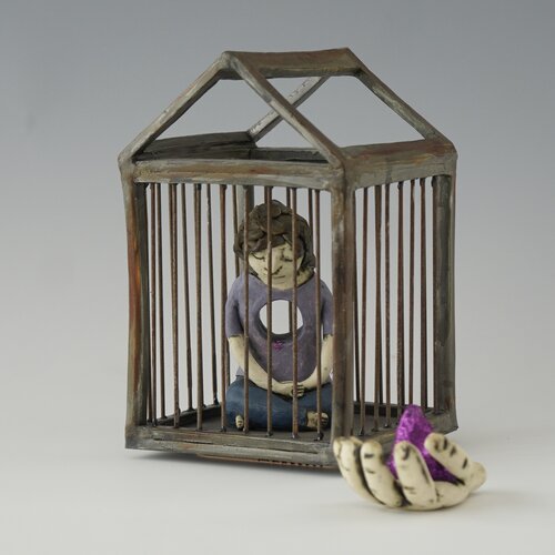 Ceramic sculpture of a young woman in a cage