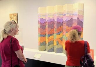 Two women viewing an art collection