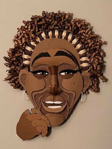 whimsical cardboard/mixed media sculpture of a woman's face