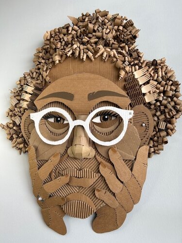 whimsical mixed media and cardboard sculpture of a woman with glasses
