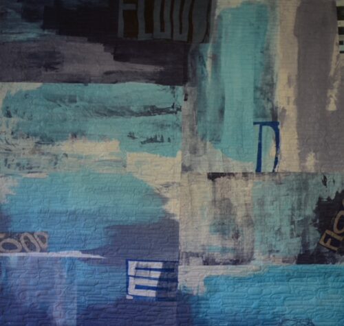 handmade quilt in cool colors with soft shapes