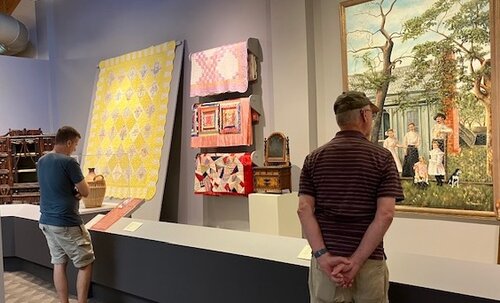 two men viewing art in a gallery
