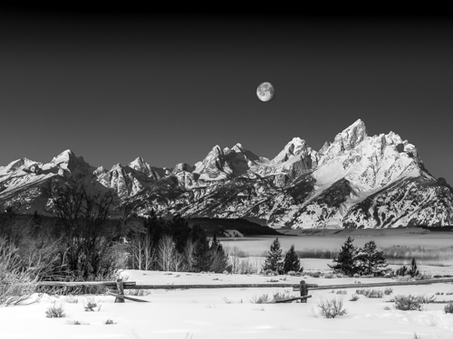 black and white art photo of the Tetons at moonrise