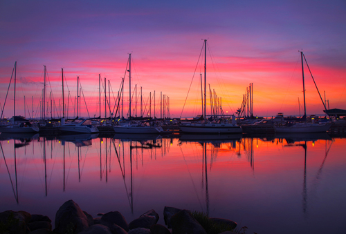 fine art photograph of sailboats at sunrise