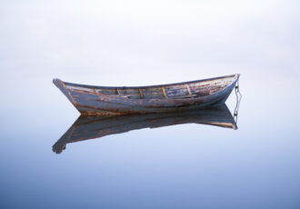 fine art photo of a lone dory on calm water