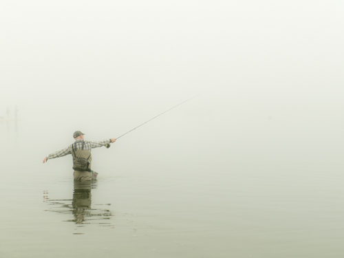 fine art photo of a fisherman casting a line