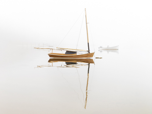 serene photograph of a boat at anchor on a lake