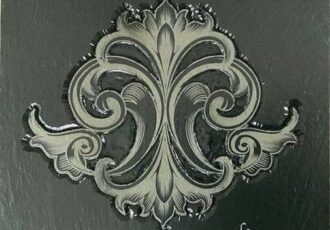 scroll design in carved bas-relief slate stone