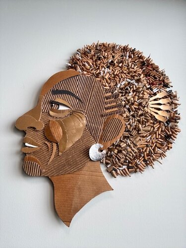 mixed media and cardboard wall sculpture of a woman's face