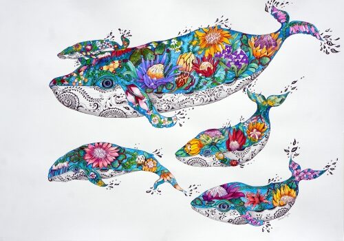 Whimsical watercolor painting of decorated whales in a pod